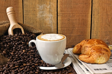 cappuccino, brioches and newspaper with background