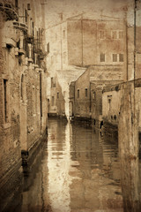 Retro and grunge view of canals of Venice