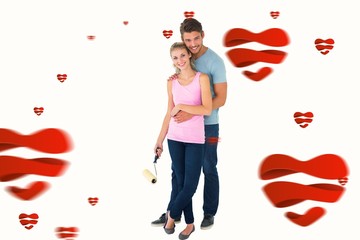 Composite image of young couple painting with roller