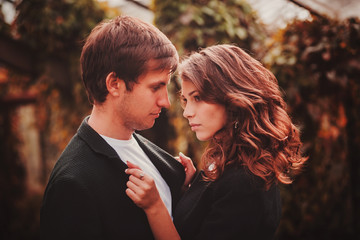 Sensual outdoor portrait of young couple posing in summer