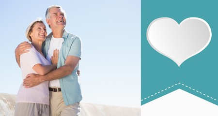 Composite image of happy senior couple embracing on the pier