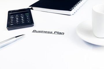 business plan words near calculator, pen and cup of coffee