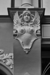 Bas-relief of a woman with wings and a star on the wall of an ol