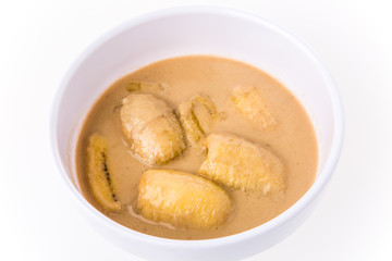 banana in coconut milk on white background.