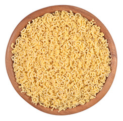 Alphabet pasta in a wooden bowl on a white