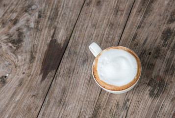 latte coffee cup on the old wood table in top view