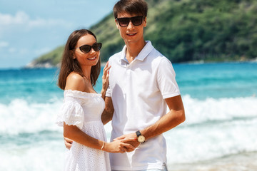 Lovely couple walking on a tropical beach