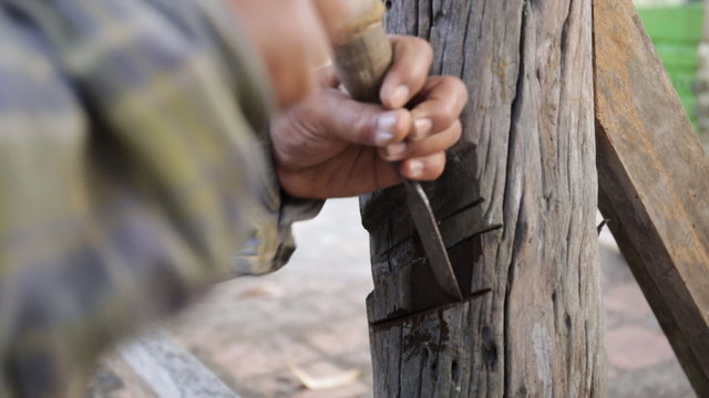 Closeup of Carpenter use equipment to repare the furniture