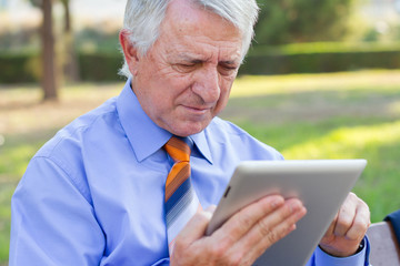 Closeup of a businessman working with a tablet