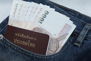 Closeup of money and passport in jeans