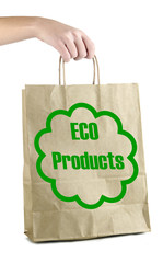 Paper bag with eco products in hand isolated on white