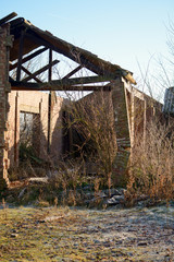 Fototapeta na wymiar Broken column and roof in derelict barn