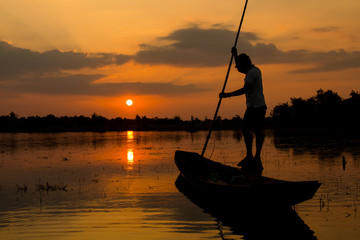 fishermen on a boat at sunrise