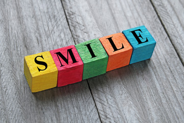 word smile on colorful wooden cubes