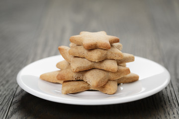 homemade star shape ginger cookies on wood table