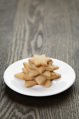 homemade star shape ginger cookies on wood table