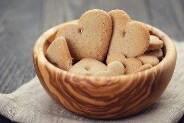 heart cookies for valentines day in olive bowl on wood table