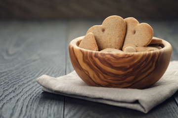 heart cookies for valentines day in olive bowl on wood table