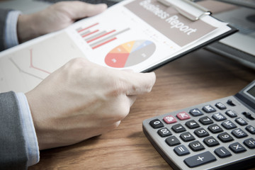 Businessman analyzing investment charts with laptop. Accounting