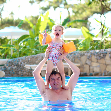 Father and child having fun in water park