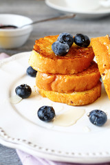 French toast with blueberries on a white plate