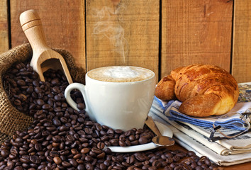 cappuccino, brioches and newspaper with background