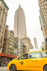 Fototapeta na wymiar NEW YORK CITY - JUNE 12, 2013: Taxi cab in city street. The are
