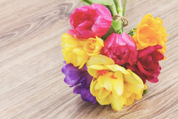 posy  of spring flowers on wooden table
