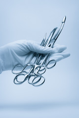 hand of surgeon with forceps