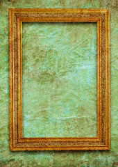 Golden frame on green wall