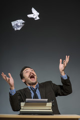 Inspired author throwing crumpled paper