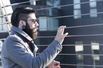 young hipster businessman look at traffic on an iron bridge