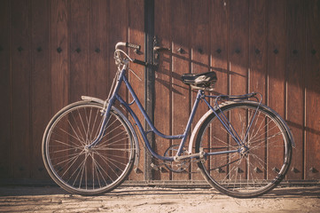 Old or classic bicycle on a wooden door