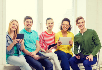 smiling students with tablet pc computer