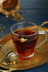 Beautiful vintage composition with herbal tea, on wooden table