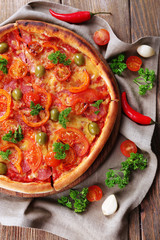 Tasty pizza with sausage and vegetables