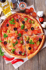 Tasty pizza with sausage, vegetables and chili pepper