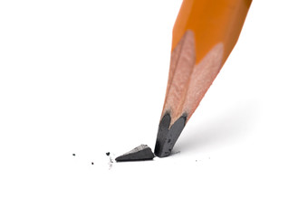 Broken head of sharp pencil on a white paper