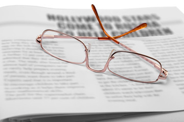 Glasses and newspapers, close-up