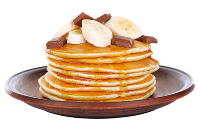 Stack of delicious pancakes with chocolate, honey and slices of