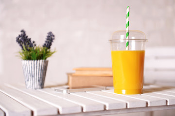 Orange juice in fast food closed cup with tube