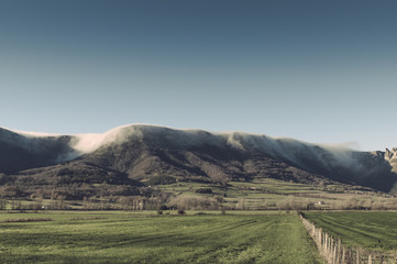 Fog falling down the slopes of the mountains