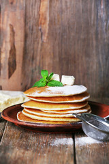 Stack of pancakes with mint and butter