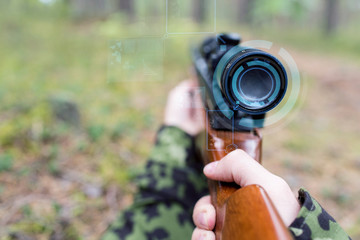 close up of soldier or sniper with gun in forest
