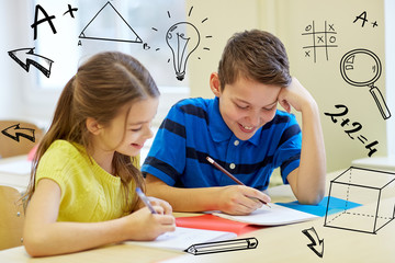 group of school kids writing test in classroom