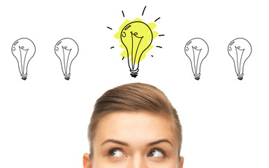 close up of woman looking to lighting bulbs