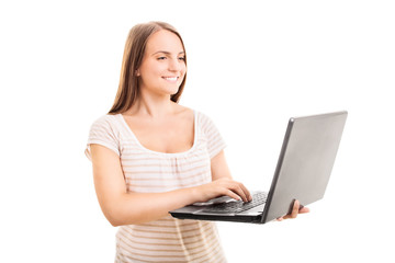 Young girl typing on a laptop