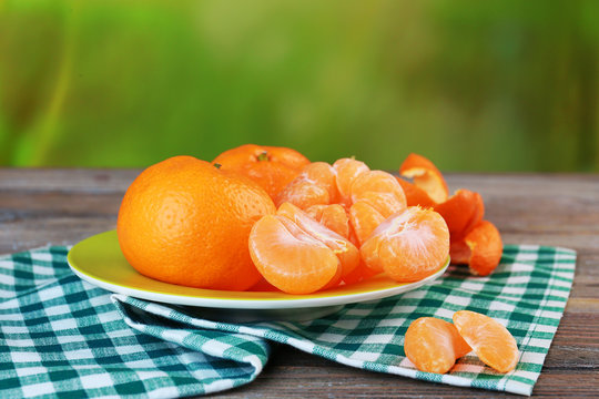 Tangerines in plate on table