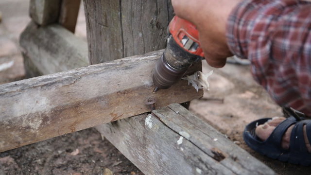 Closeup of Carpenter use equipment to repare the furniture