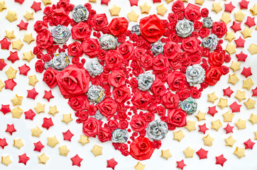 Roses from paper dacorated in hearth shape among star background